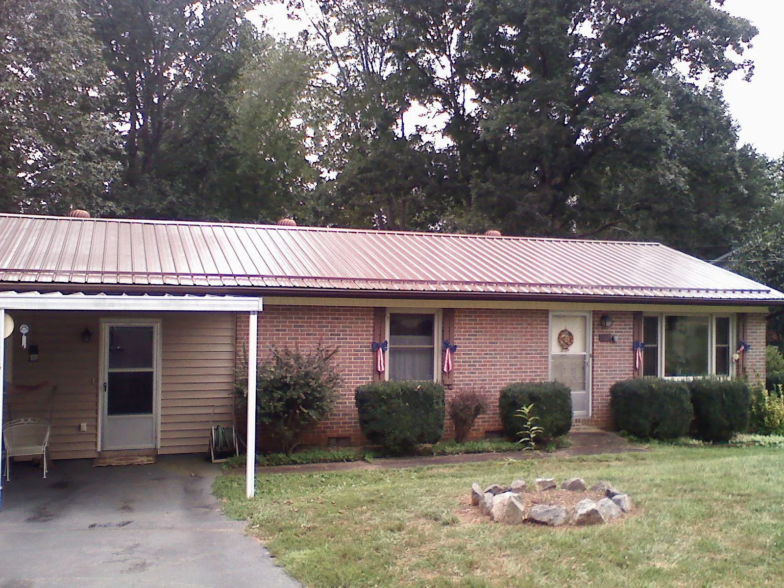 Bronze metal roof and carport on a brick ranch home — Roof Repair work by our crew in Cedarhurst